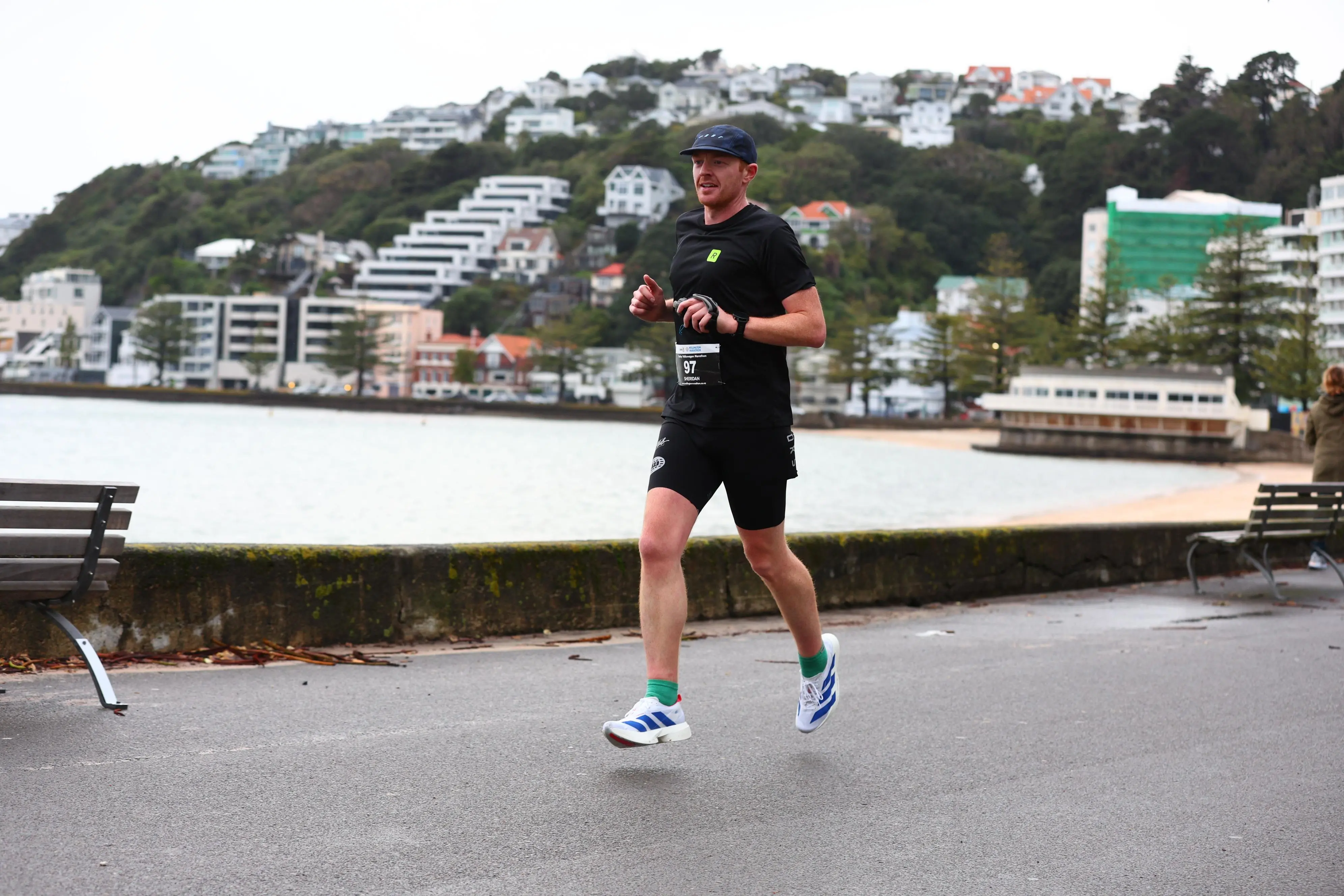 Sheridan Jamieson running the Wellington Marathon in Run With Run Club gear, demonstrating real 3:11:52 PB results